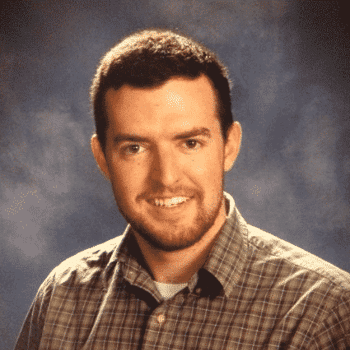 a man in a plaid shirt smiling for a picture.