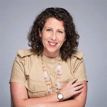 a woman with her arms crossed posing for a picture.