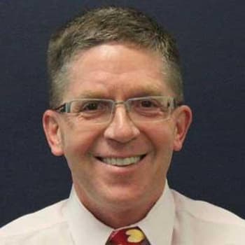 a man wearing glasses and a red tie.