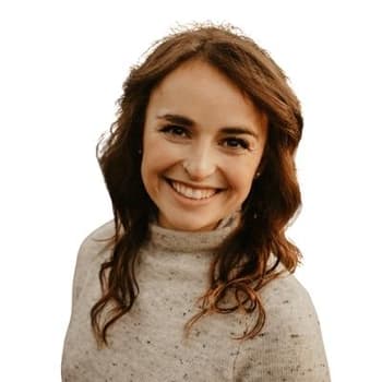 a woman with long brown hair smiling at the camera.