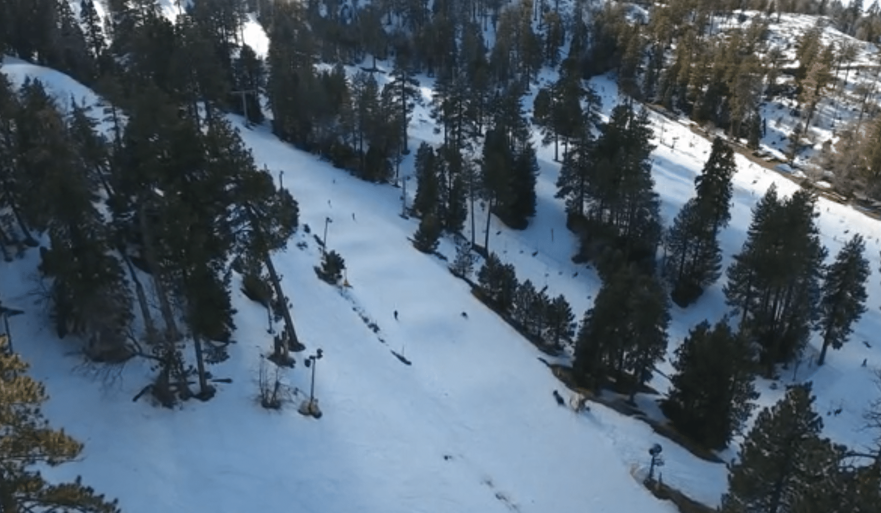 an aerial view of a snow covered ski slope.