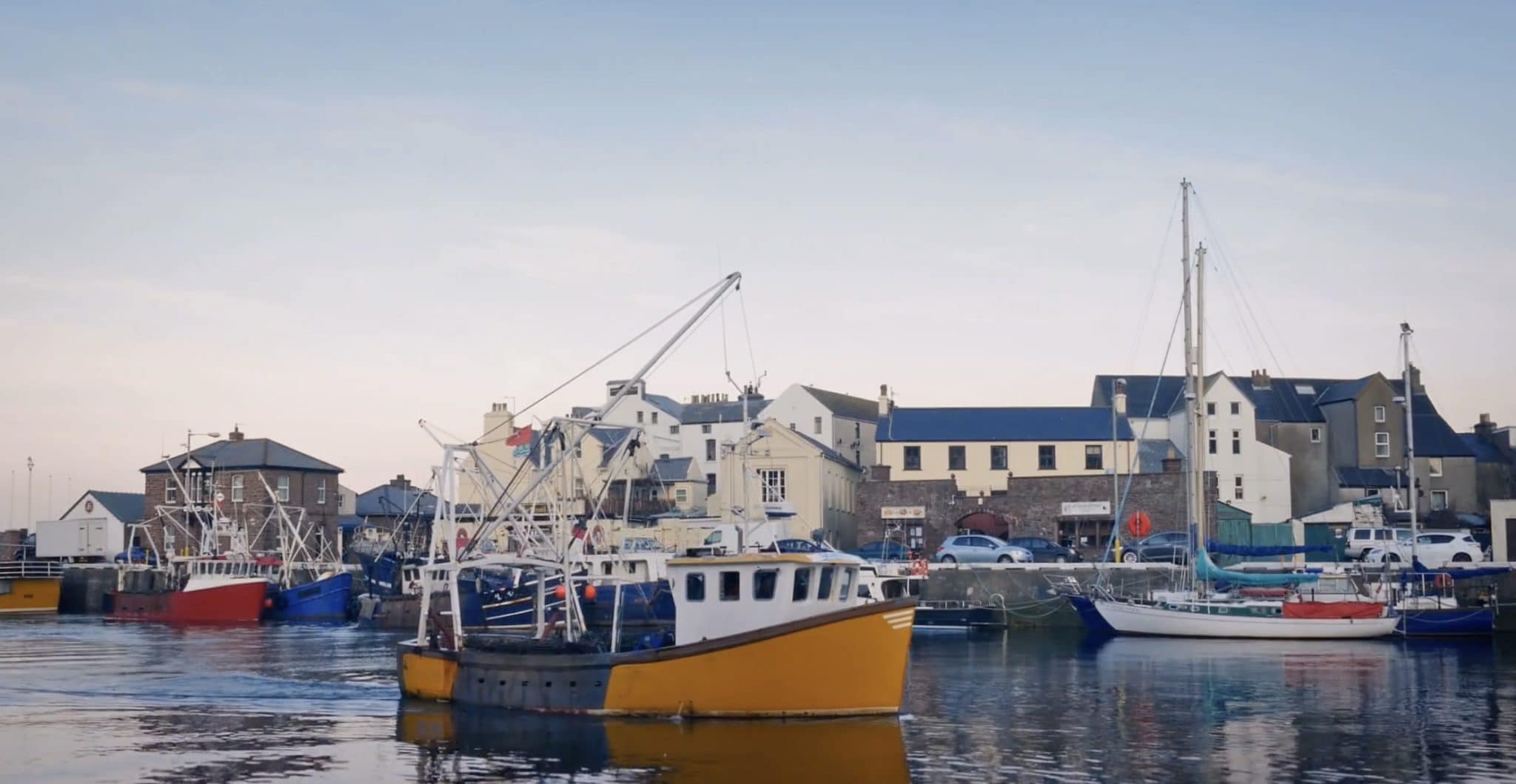 a group of boats that are sitting in the water.