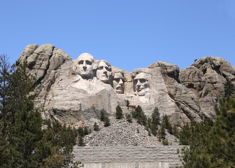 a group of presidents carved into the side of a mountain.