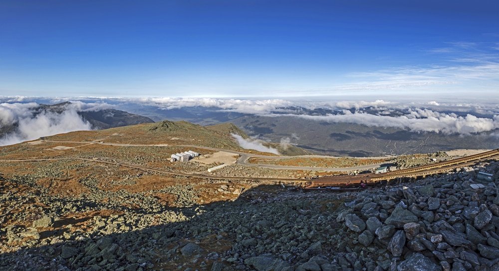 a view of a mountain range with a train on it.