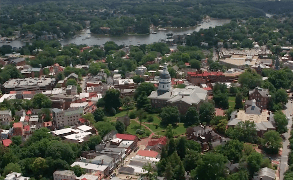 an aerial view of a city with a river in the background.