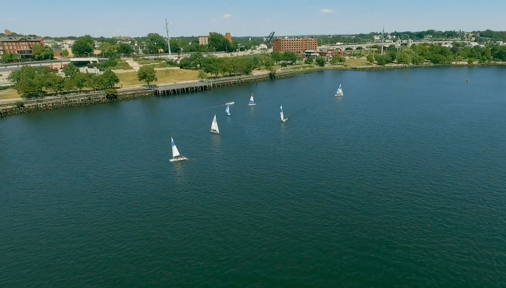 a group of sailboats floating on top of a lake.