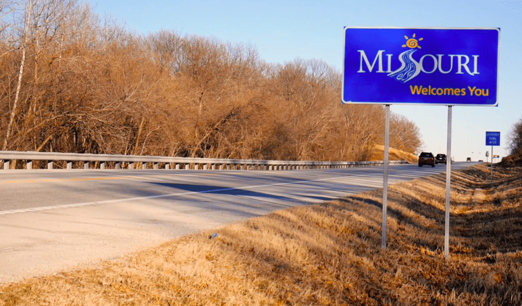 a blue sign on the side of a road.