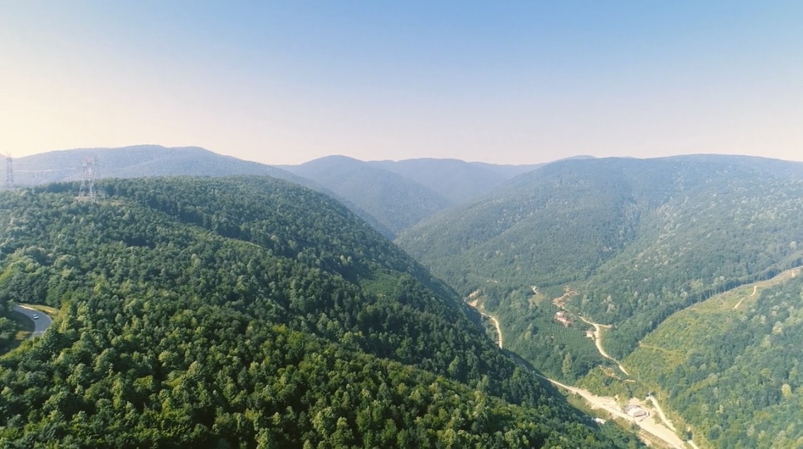 an aerial view of a mountain valley with a river running through it.