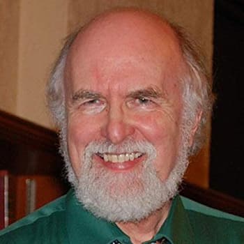 a man with a beard wearing a green shirt and tie.