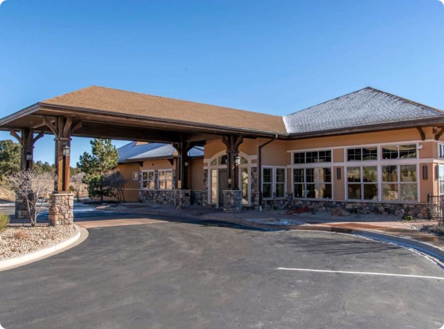 a large building with a parking lot in front of it.