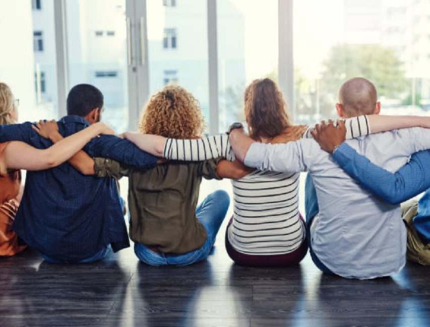 a group of people sitting in a circle.