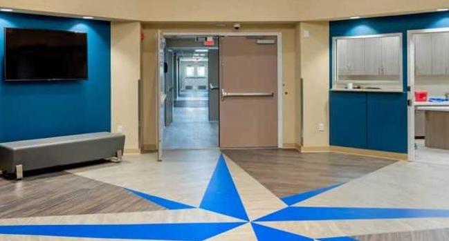 a large room with a blue star painted on the floor.