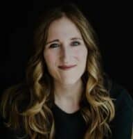 a woman with long hair and a black shirt.