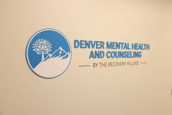 a sign that says denver mental health and consulting by the recovery village.
