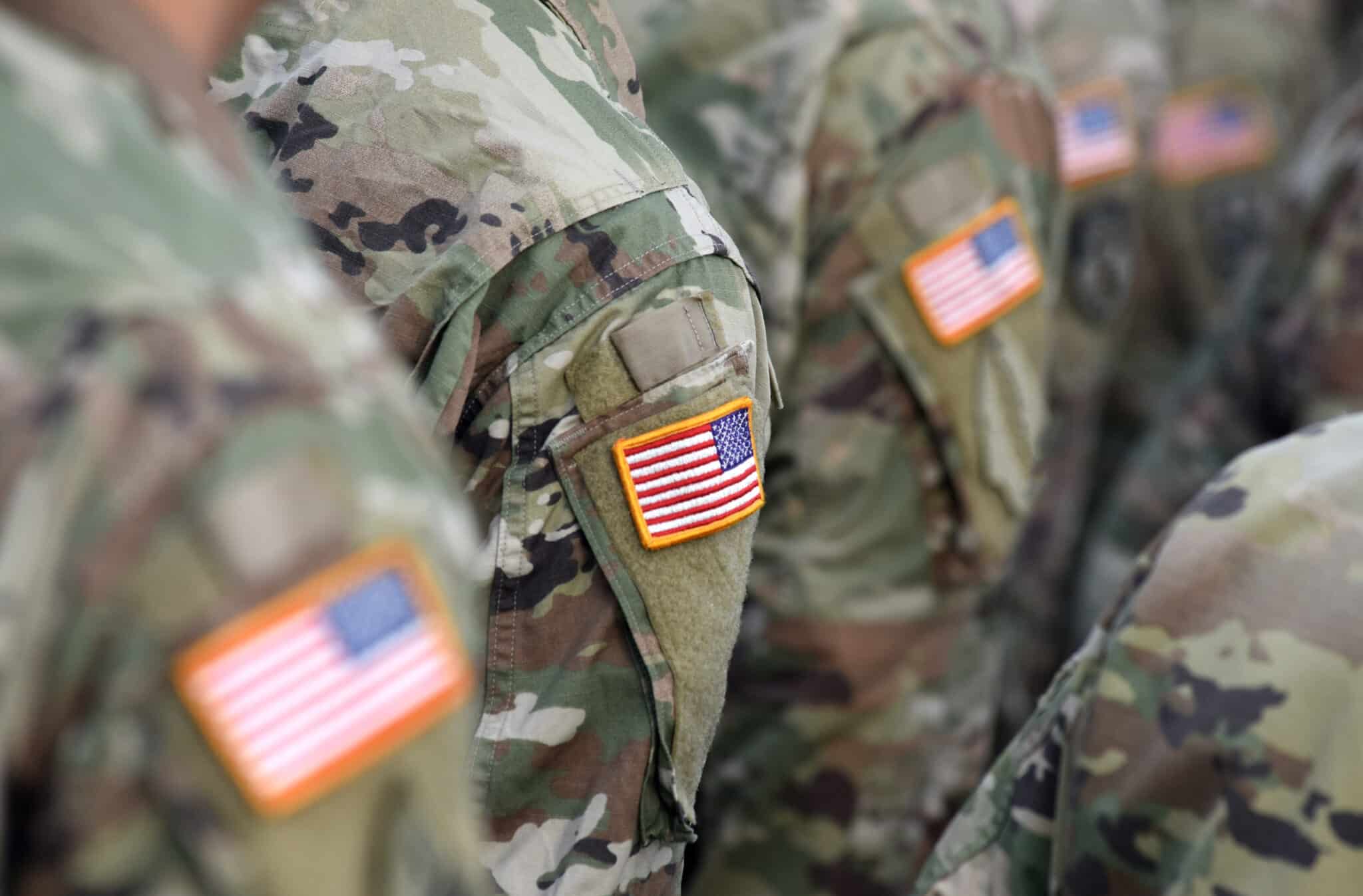 a group of soldiers with american flags on their uniforms.
